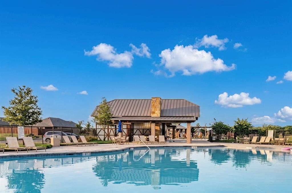 816 Country Road Royse City, TX 75189 - Photo 24 of 24 Resort-style pool area featuring a large swimming pool, a covered pavilion with stone accents and a metal roof, and surrounding hardscaping
