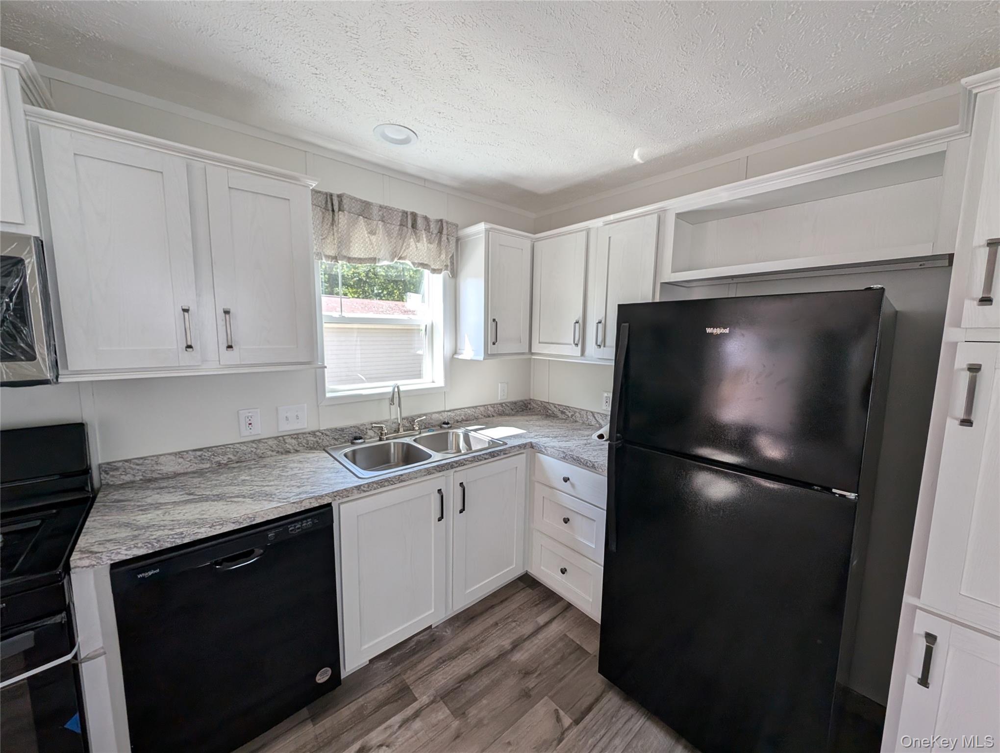 3146 Rte 9W, Unit 6A New Windsor, NY 12553 - Photo 6 of 14 Kitchen featuring dark wood-style flooring, a textured ceiling, a sink, light countertops, and black appliances