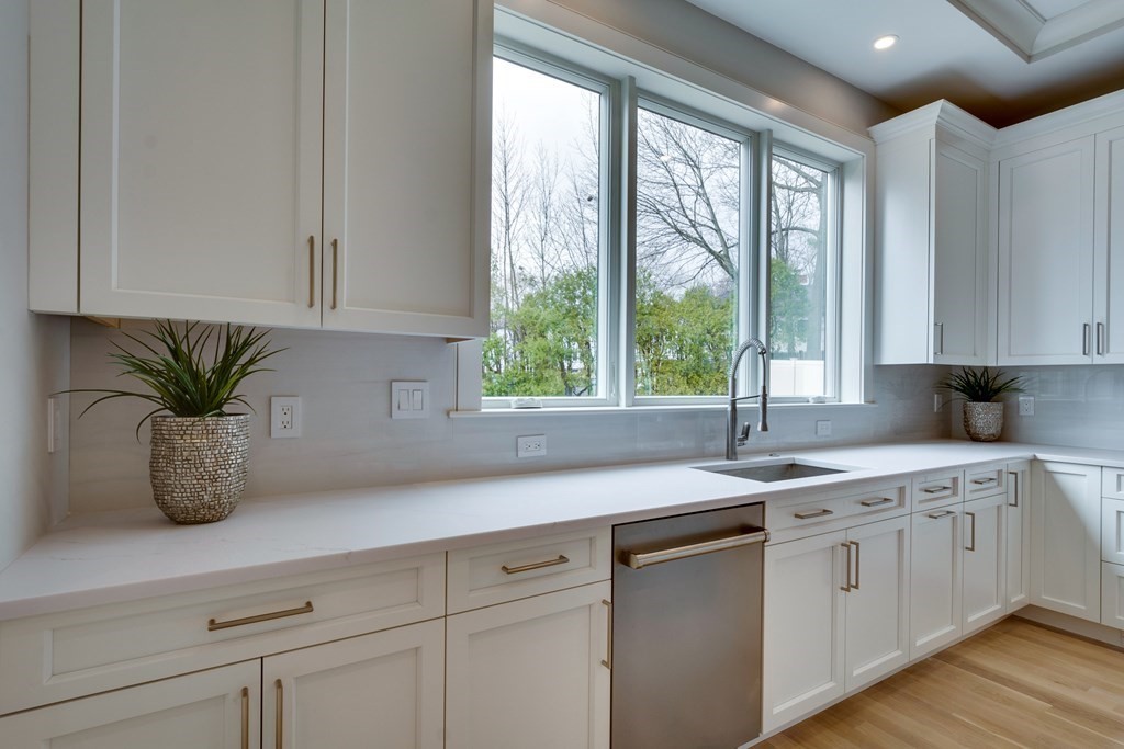 192 Evelyn Road Newton, MA 02468 - Photo 11 of 41 a kitchen with white cabinets and a window