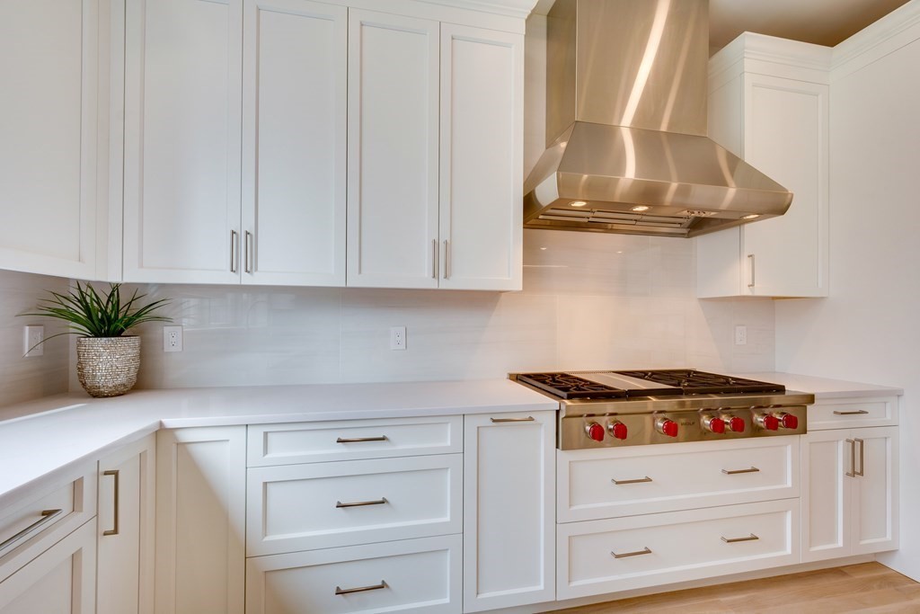 192 Evelyn Road Newton, MA 02468 - Photo 12 of 41 a kitchen with white cabinets and appliances