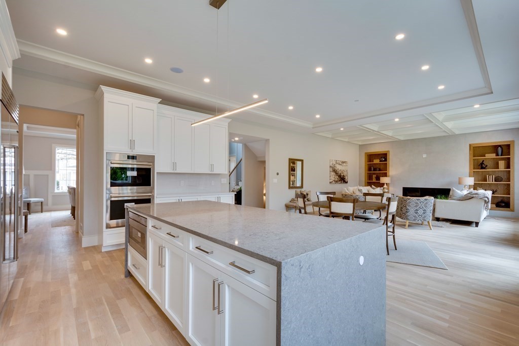 192 Evelyn Road Newton, MA 02468 - Photo 13 of 41 a view of a kitchen with kitchen island a stove a sink a refrigerator and chairs