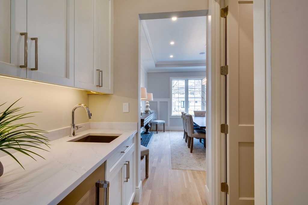 192 Evelyn Road Newton, MA 02468 - Photo 15 of 41 a kitchen with a sink dishwasher and a refrigerator with wooden floor