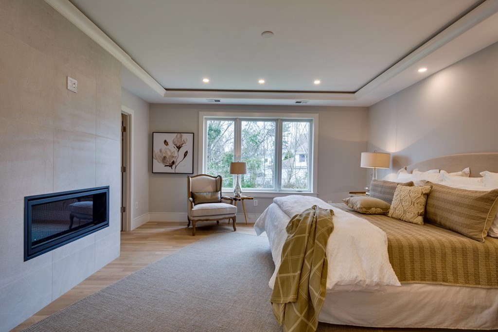 192 Evelyn Road Newton, MA 02468 - Photo 25 of 41 a bedroom with furniture and a fireplace