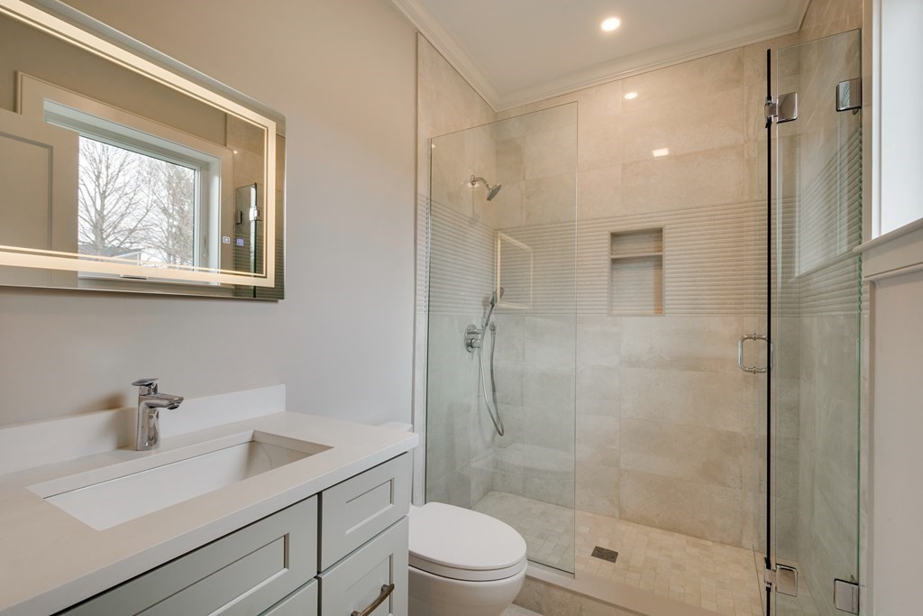 192 Evelyn Road Newton, MA 02468 - Photo 31 of 41 a bathroom with a shower sink vanity mirror and toilet