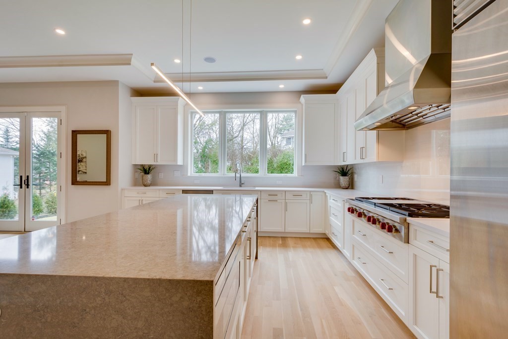 192 Evelyn Road Newton, MA 02468 - Photo 8 of 41 a kitchen with wooden floor and a stove