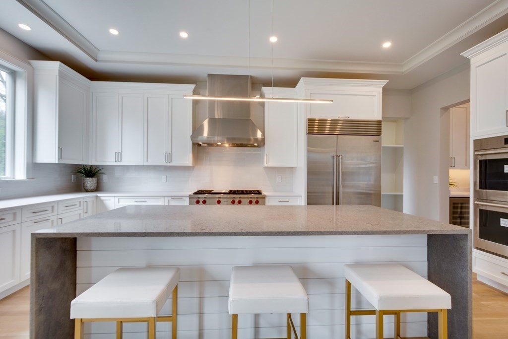 192 Evelyn Road Newton, MA 02468 - Photo 10 of 41 a large kitchen with stainless steel appliances kitchen island granite countertop a stove a sink and a refrigerator
