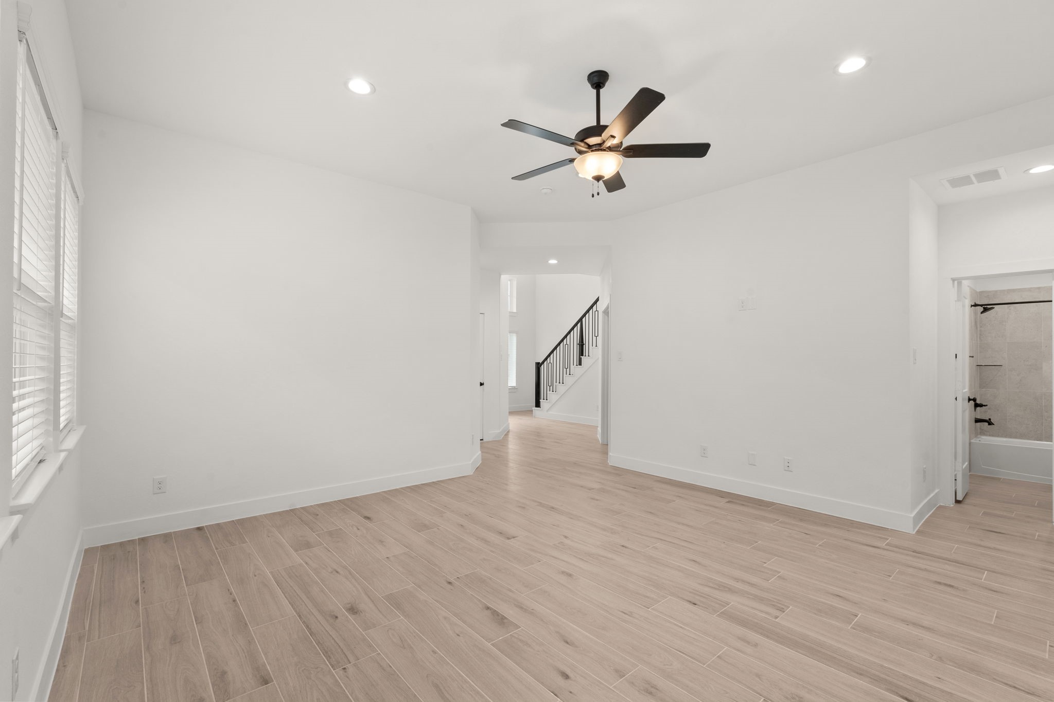 329 Rock Rose Path Willis, TX 77318 - Photo 11 of 36 a view of empty room with wooden floor and fan