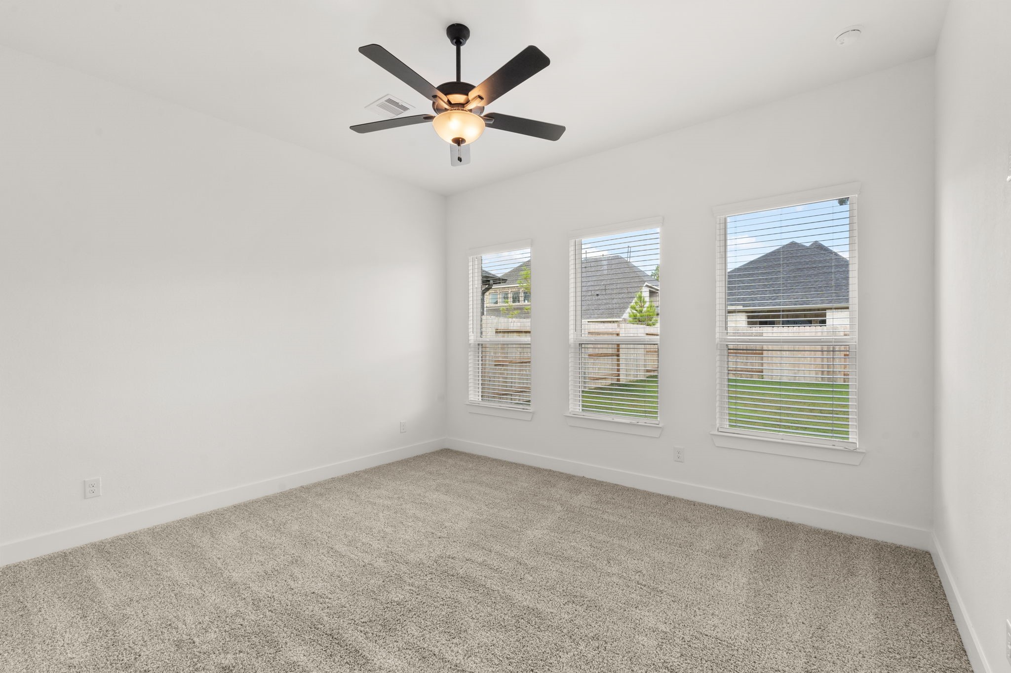 329 Rock Rose Path Willis, TX 77318 - Photo 13 of 36 an empty room with windows and fan