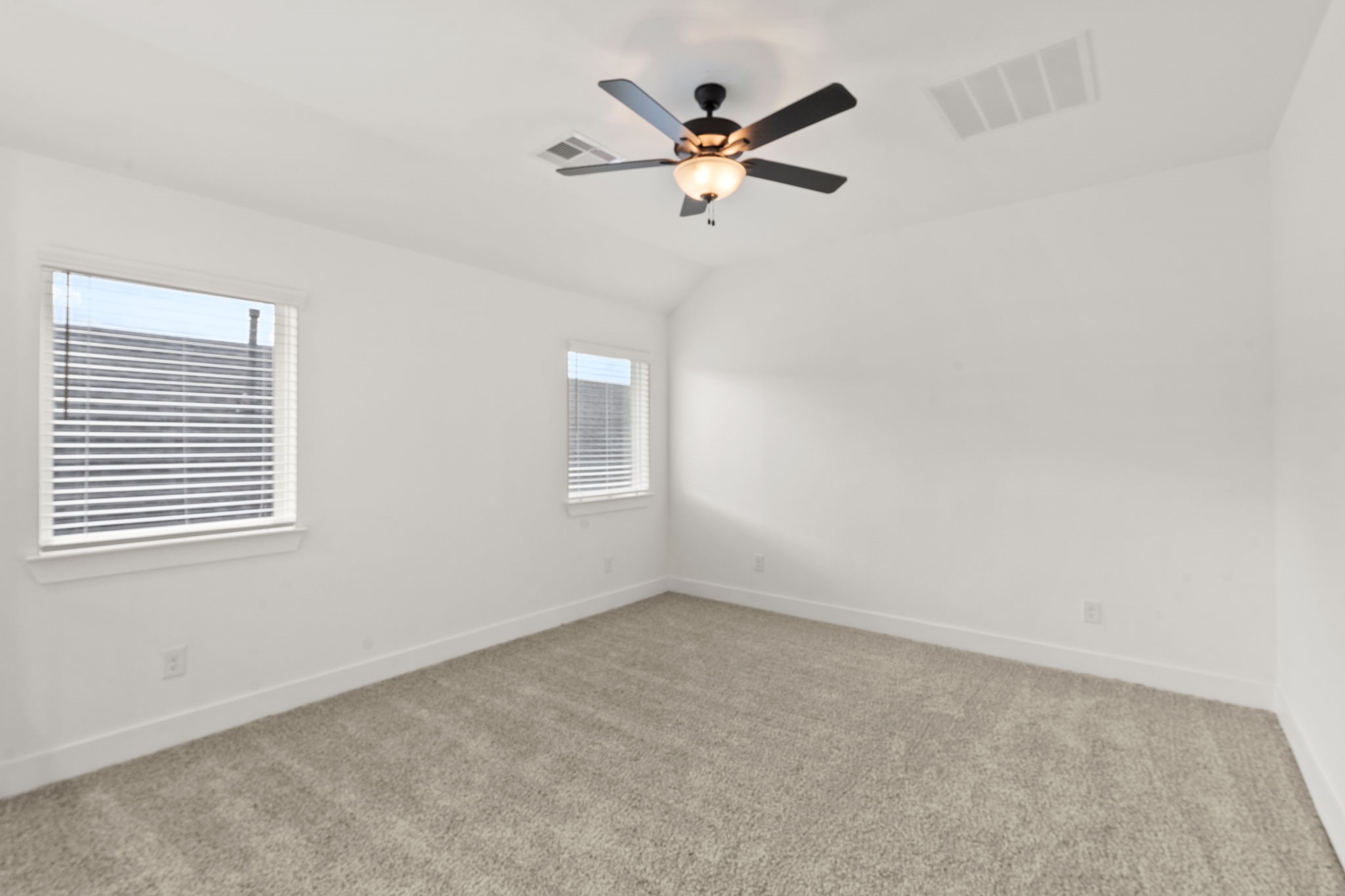 329 Rock Rose Path Willis, TX 77318 - Photo 17 of 36 an empty room with a window and a fan