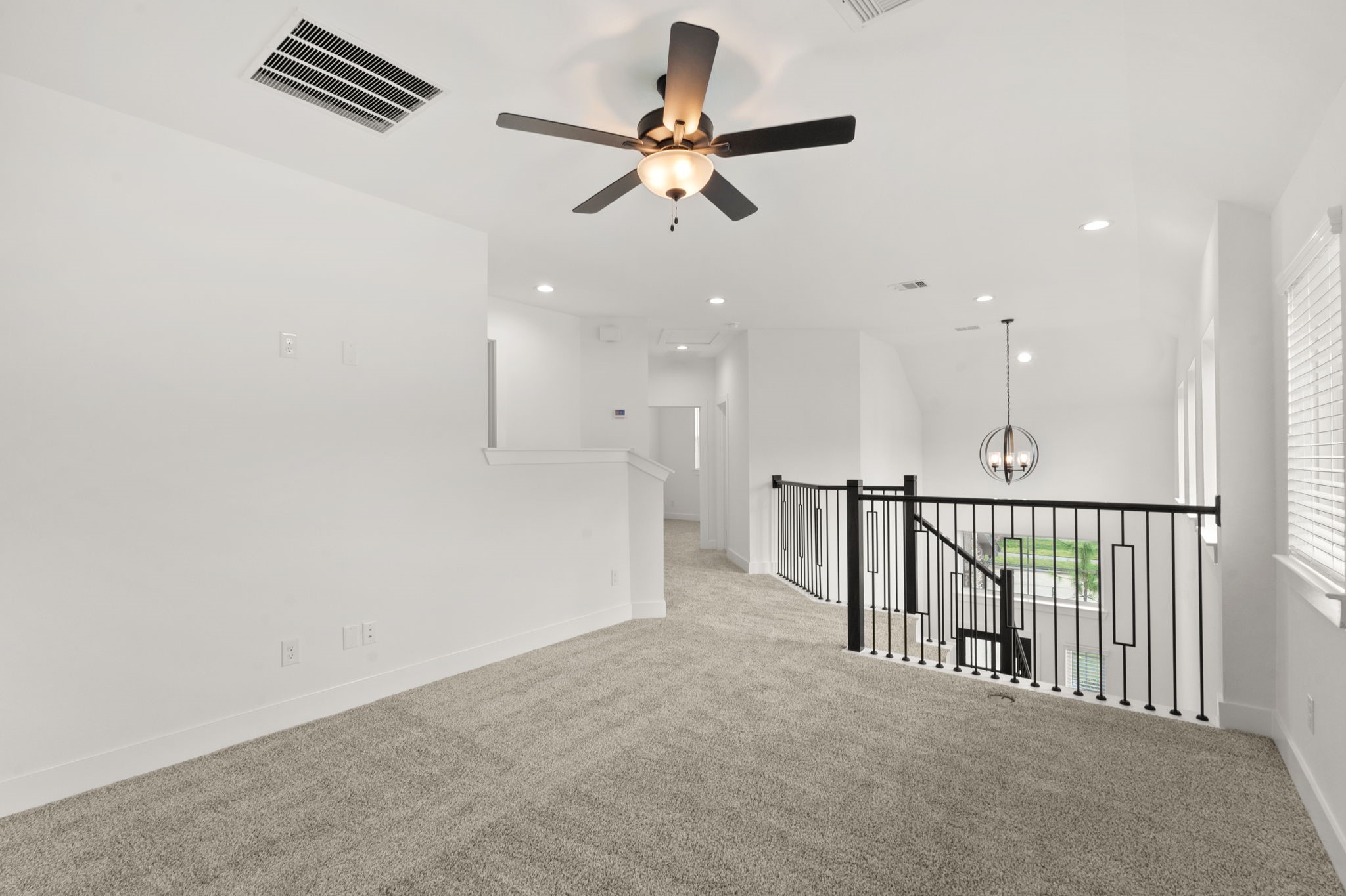 329 Rock Rose Path Willis, TX 77318 - Photo 18 of 36 a view of a hallway with a ceiling fan