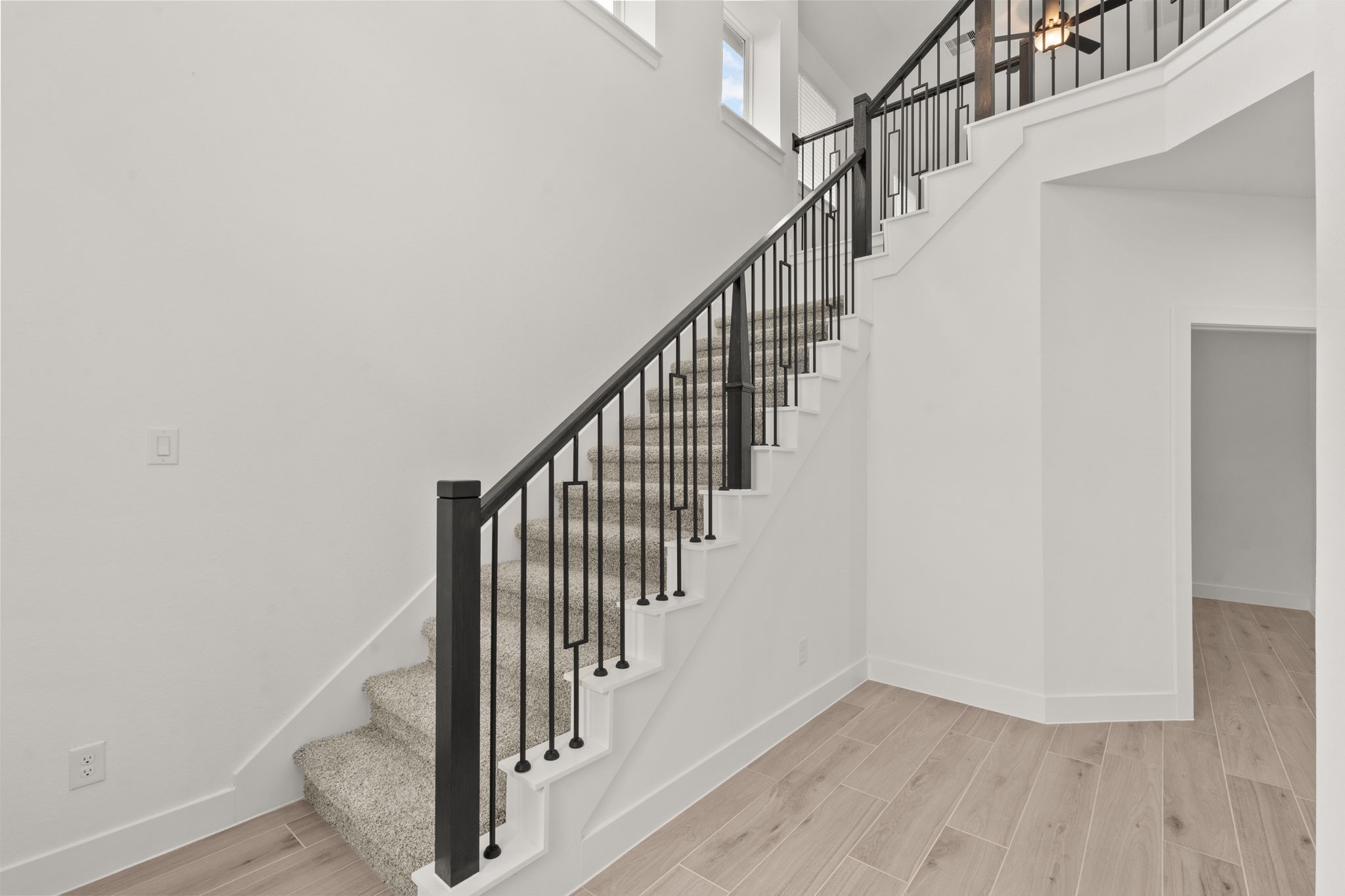 329 Rock Rose Path Willis, TX 77318 - Photo 2 of 36 a view of staircase with wooden floor and white walls