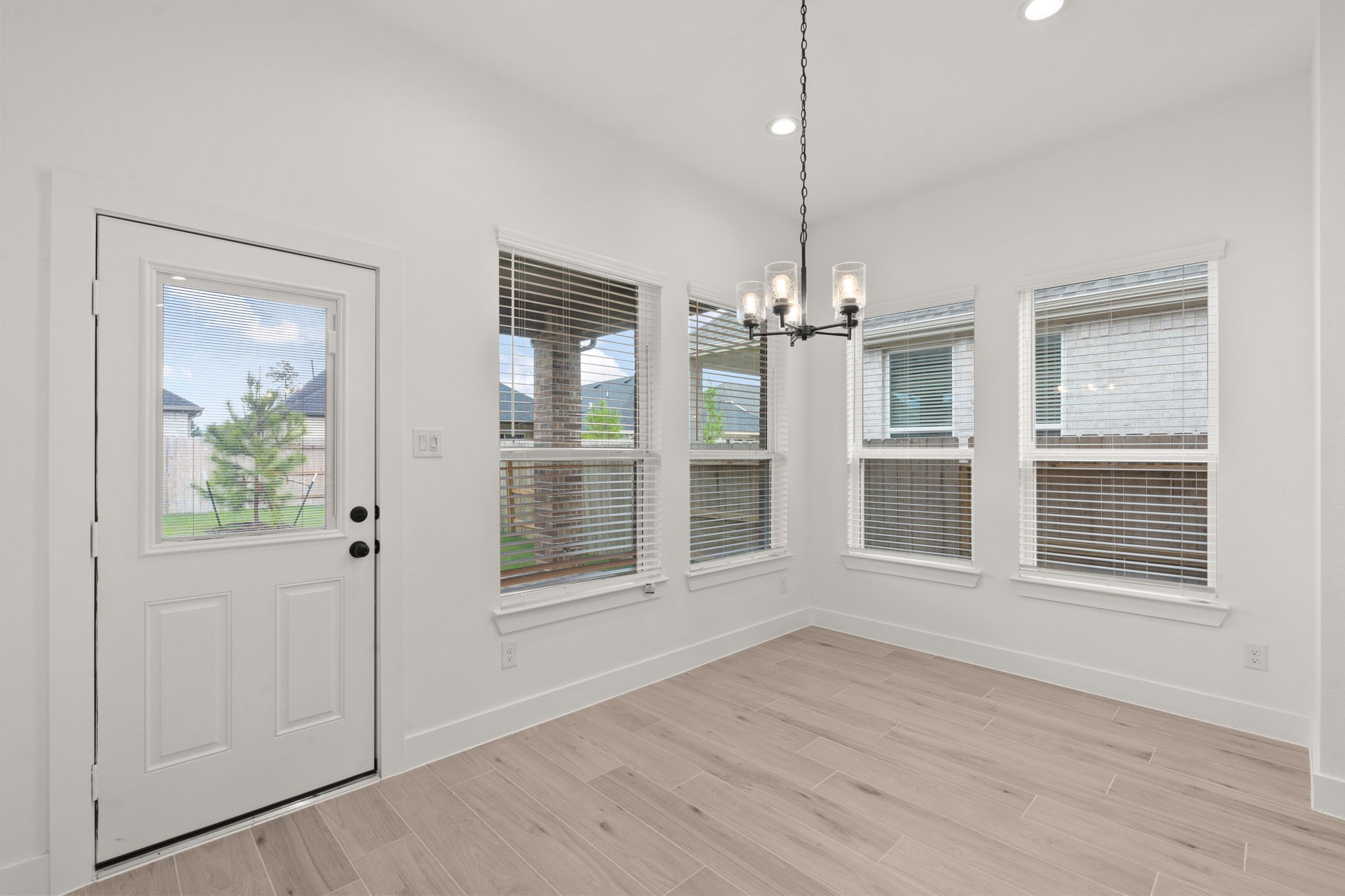 329 Rock Rose Path Willis, TX 77318 - Photo 8 of 36 a view of wooden floor and windows in a room