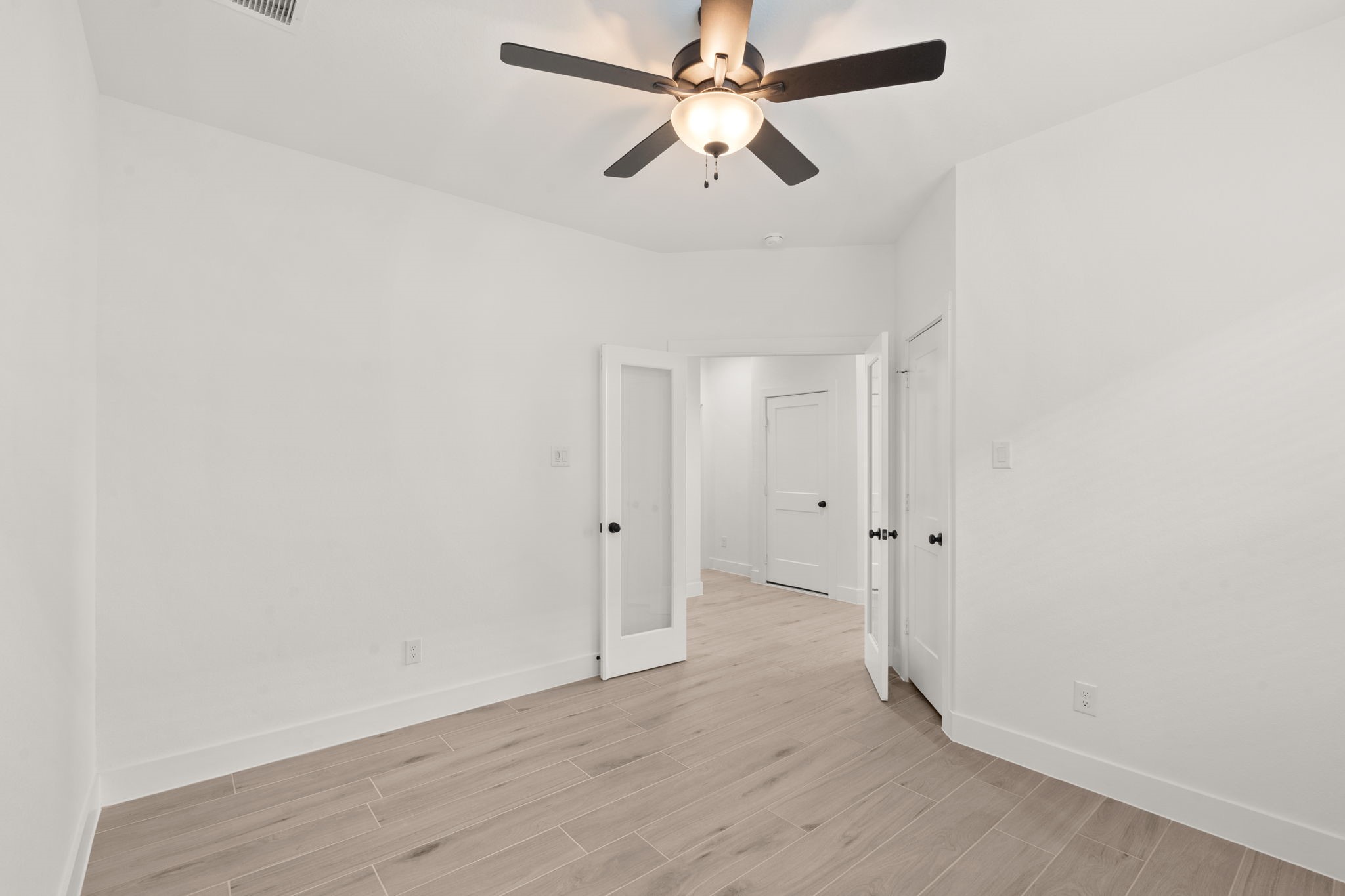 329 Rock Rose Path Willis, TX 77318 - Photo 10 of 36 a view of a room with wooden floor