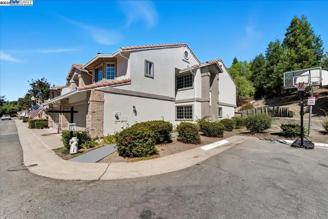 a view of a white house with a outdoor space