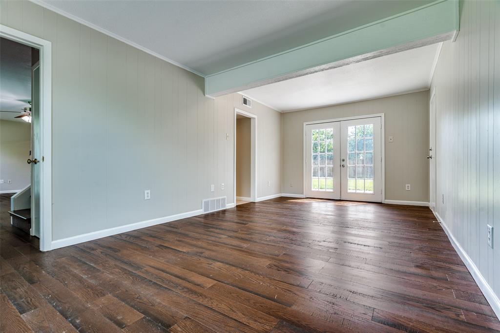 1202 Quill Drive Plano, TX 75075 - Photo 17 of 28 a view of an empty room with wooden floor and a window