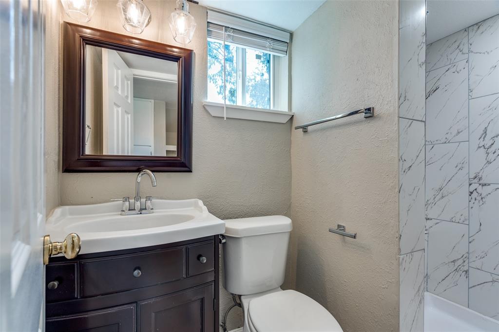 1202 Quill Drive Plano, TX 75075 - Photo 20 of 28 a bathroom with a toilet sink and mirror