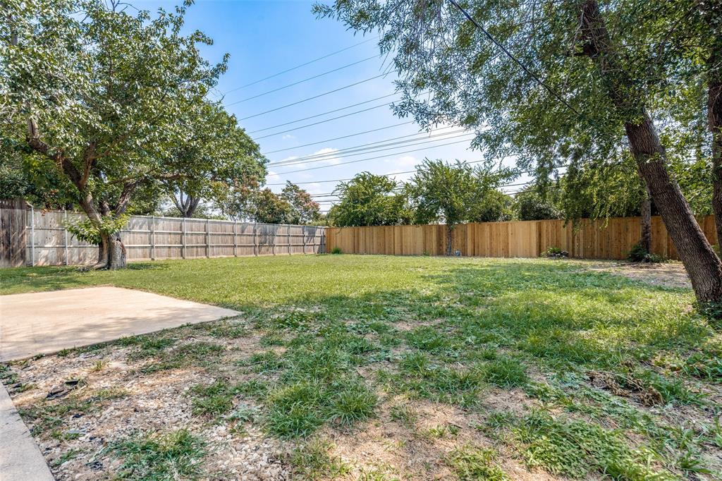 1202 Quill Drive Plano, TX 75075 - Photo 25 of 28 a view of a backyard with a garden