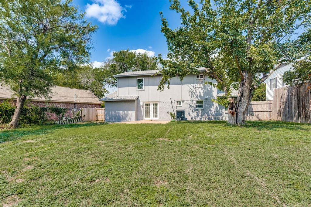1202 Quill Drive Plano, TX 75075 - Photo 27 of 28 a view of a backyard with plants and large trees
