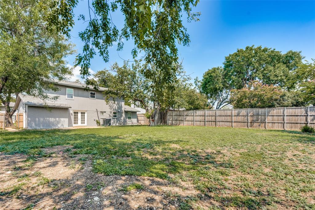 1202 Quill Drive Plano, TX 75075 - Photo 28 of 28 a view of a backyard with large trees