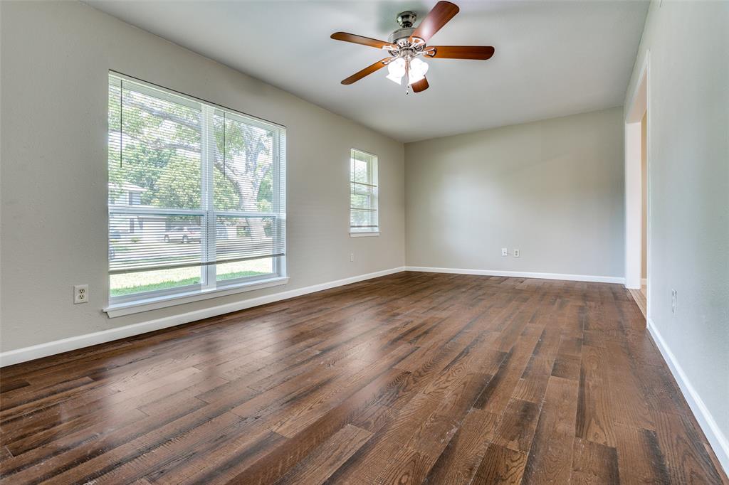1202 Quill Drive Plano, TX 75075 - Photo 6 of 28 a view of empty room with wooden floor and fan