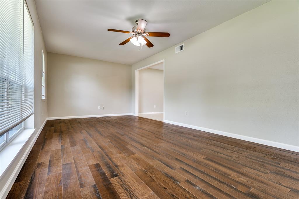 1202 Quill Drive Plano, TX 75075 - Photo 7 of 28 wooden floor in an empty room with a window