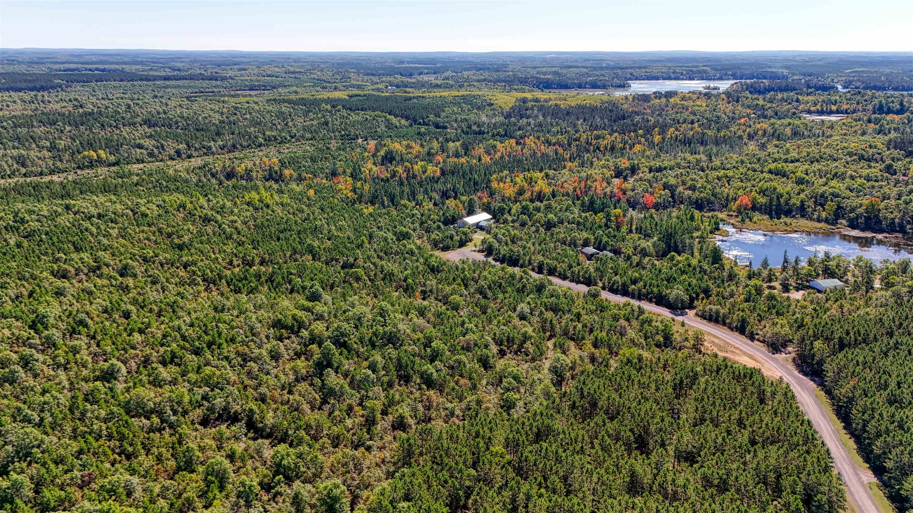 Lot 18 Cove Lane Gordon, WI 54838 - Photo 5 of 25 Drone / aerial view of a heavily wooded area and a nearby body of water
