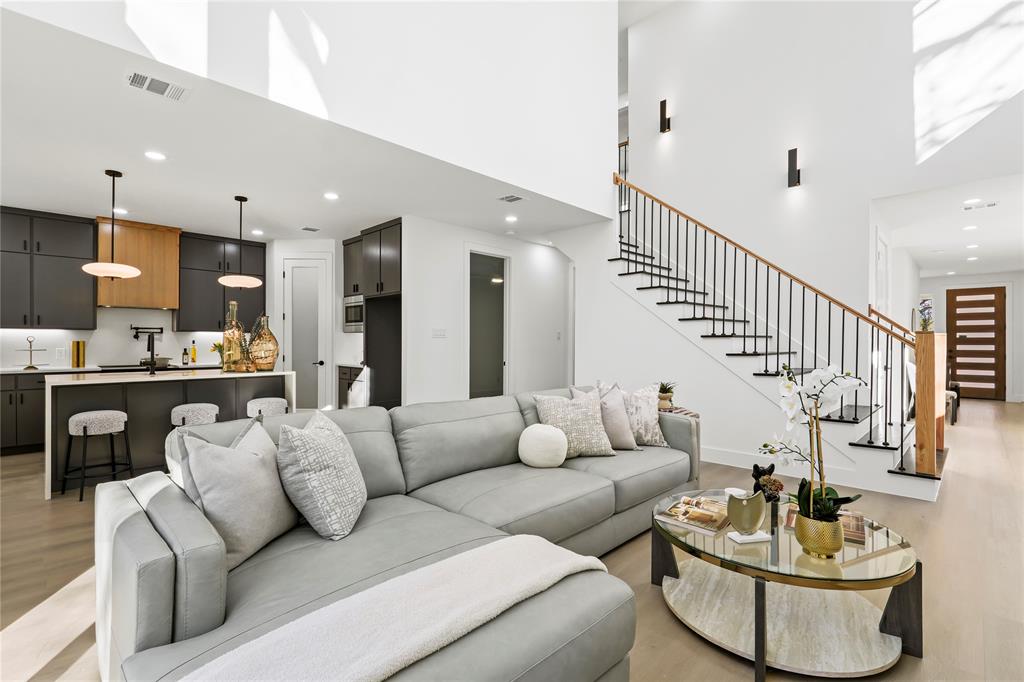 459 Hart Street Dallas, TX 75203 - Photo 6 of 21 Living area with stairs, light wood finished floors, a high ceiling, and recessed lighting