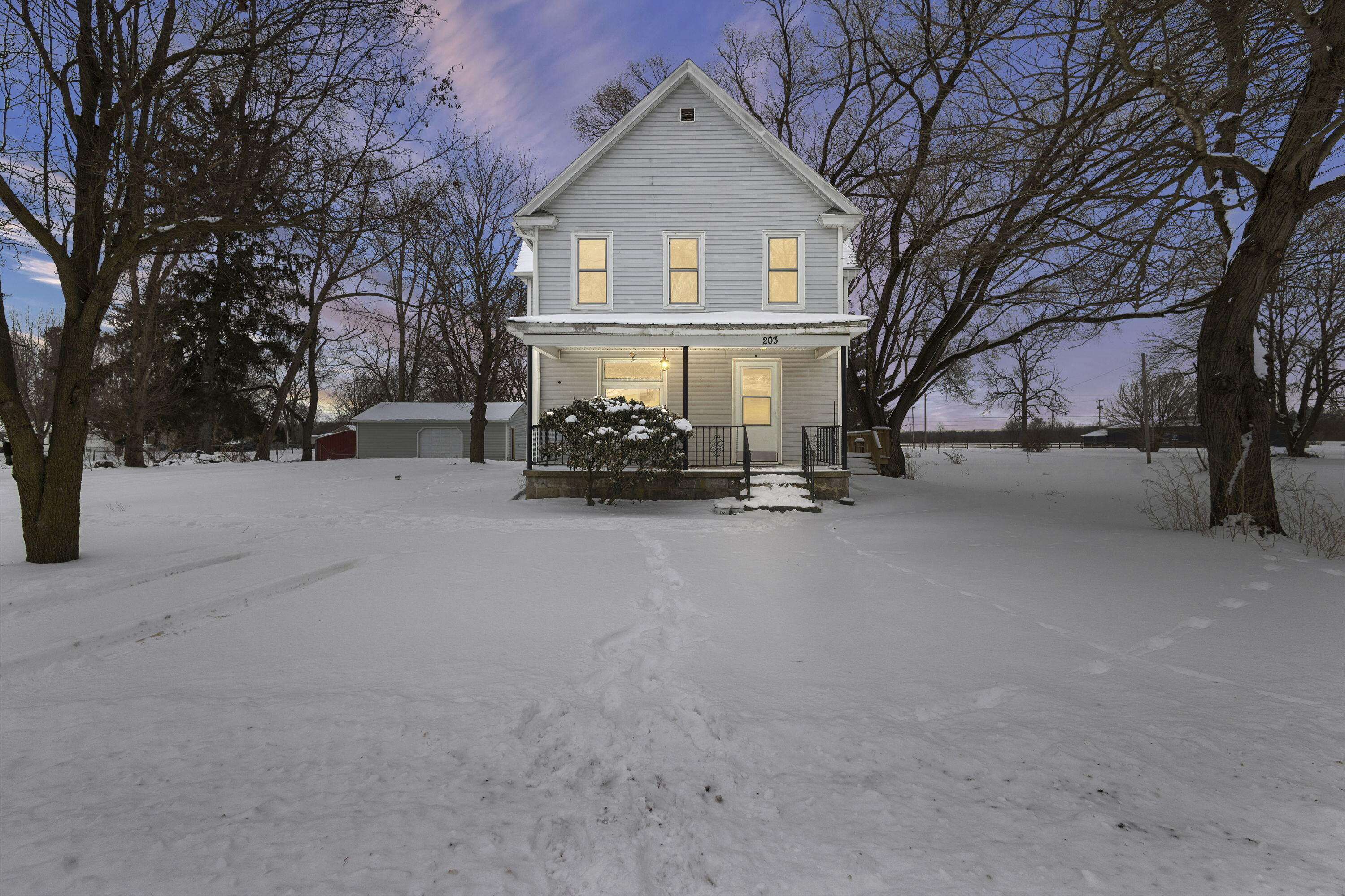 a view of a house with a snow in front of it