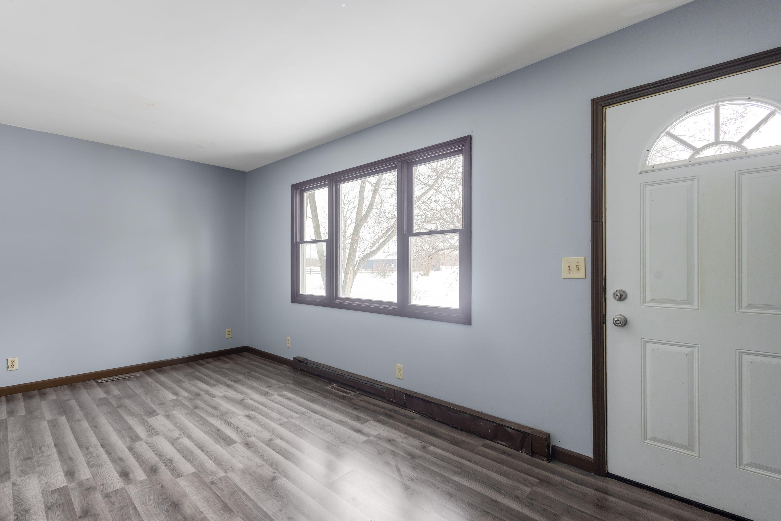 203 North Main Street Kingsbury, IN 46350 - Photo 14 of 32 a view of an empty room with wooden floor and a window