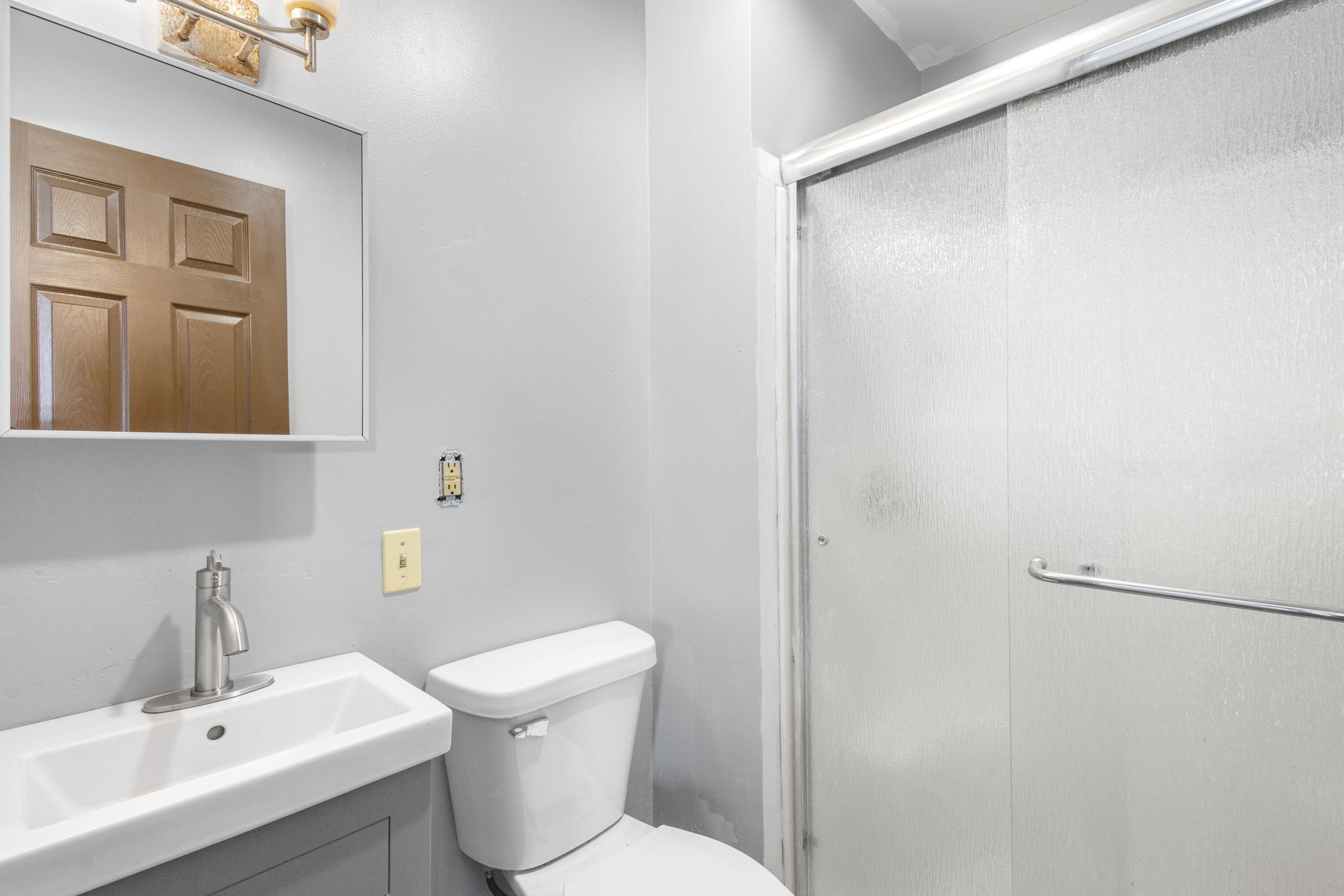 203 North Main Street Kingsbury, IN 46350 - Photo 15 of 32 a bathroom with a sink a toilet and mirror