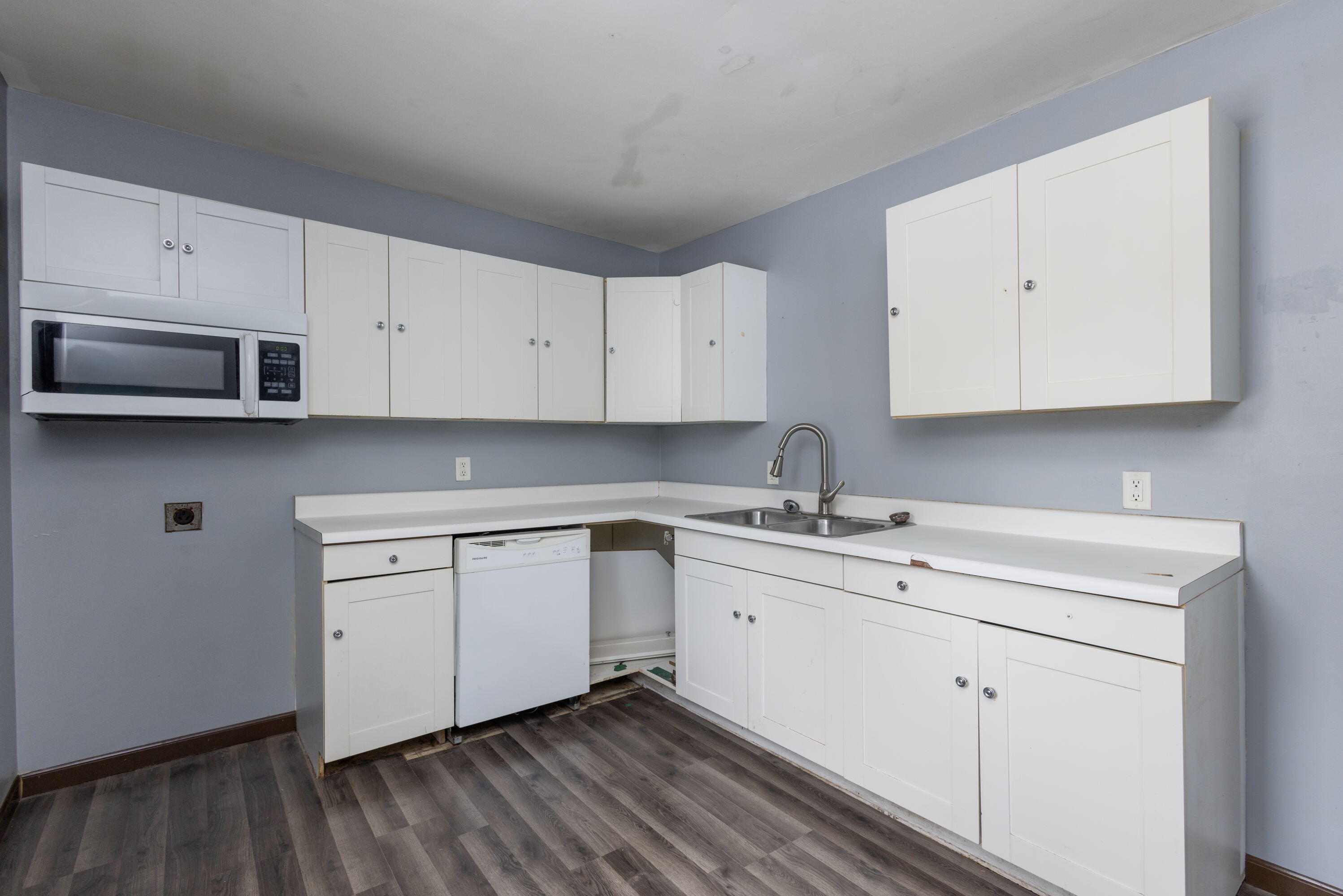 203 North Main Street Kingsbury, IN 46350 - Photo 17 of 32 a kitchen with stainless steel appliances granite countertop a sink a stove and cabinets