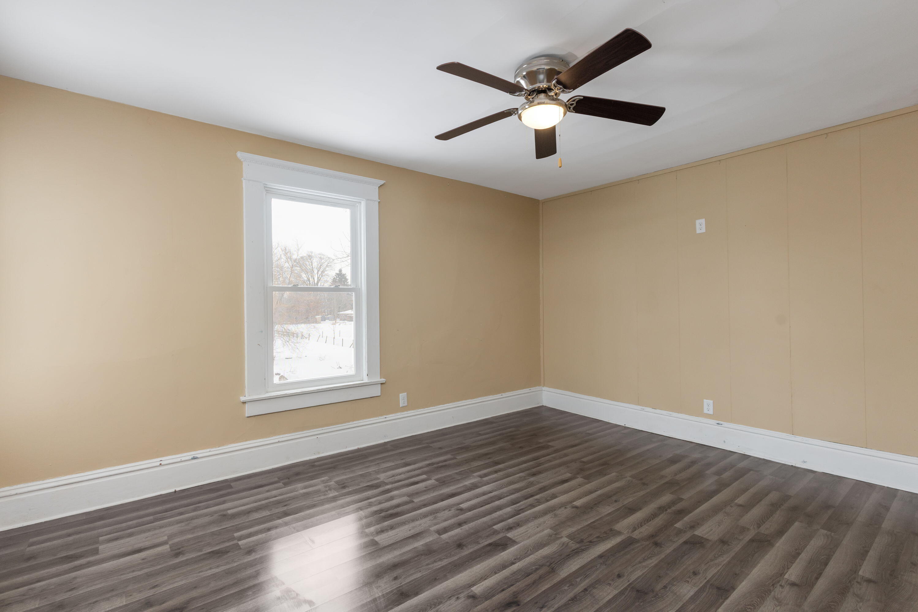 203 North Main Street Kingsbury, IN 46350 - Photo 24 of 32 an empty room with wooden floor and windows