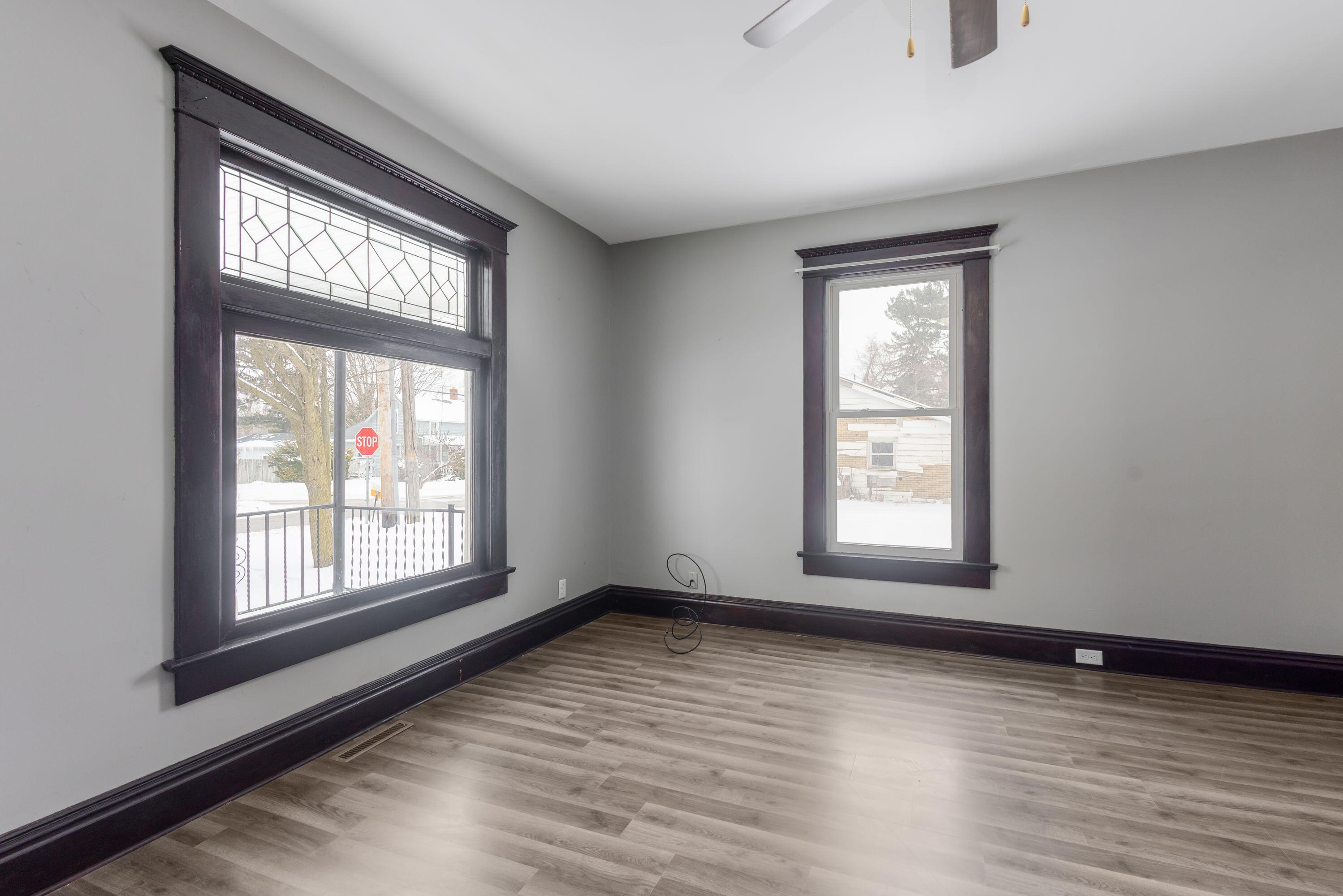 203 North Main Street Kingsbury, IN 46350 - Photo 5 of 32 an empty room with wooden floor and windows