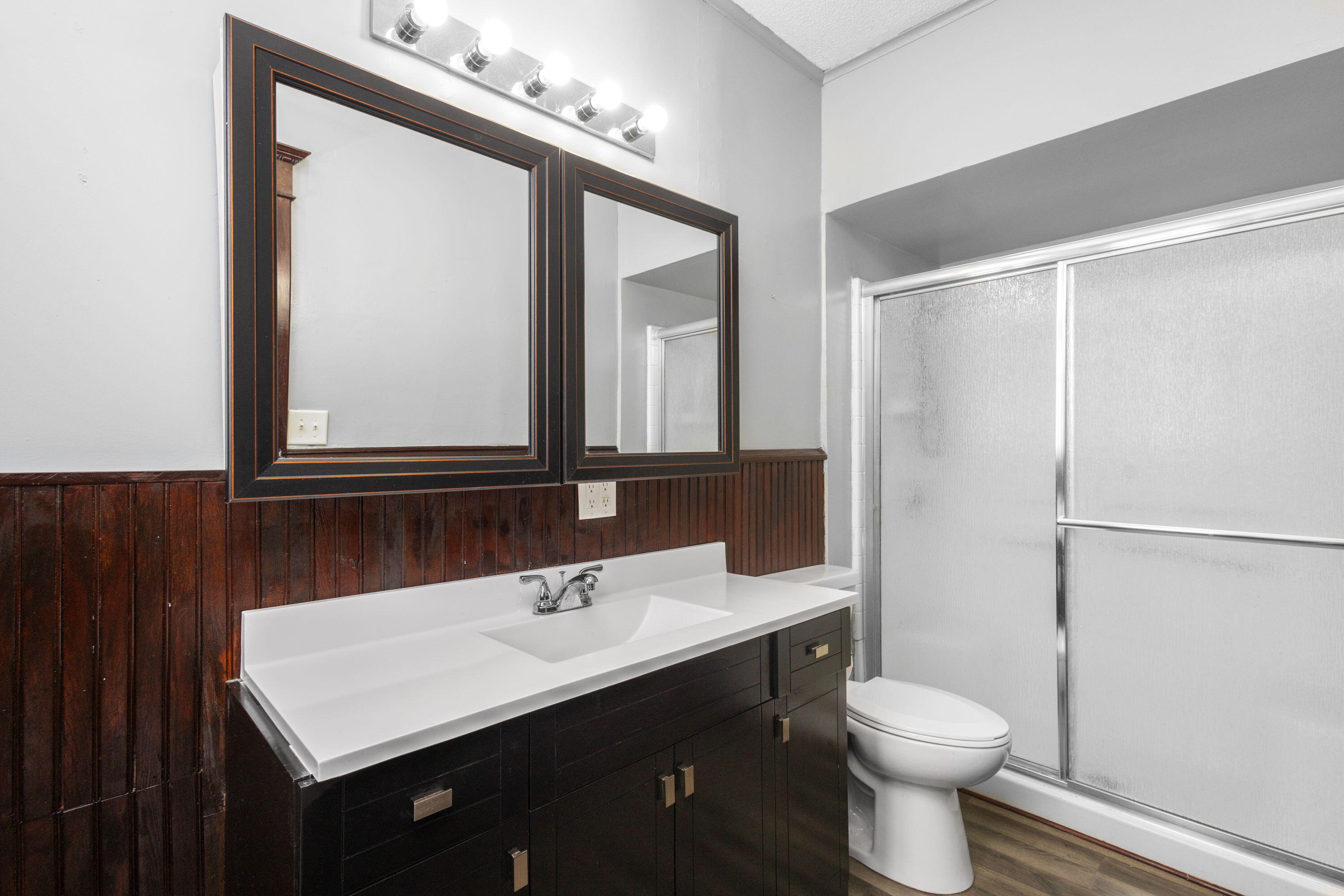 203 North Main Street Kingsbury, IN 46350 - Photo 8 of 32 a bathroom with a toilet a sink a vanity and mirror