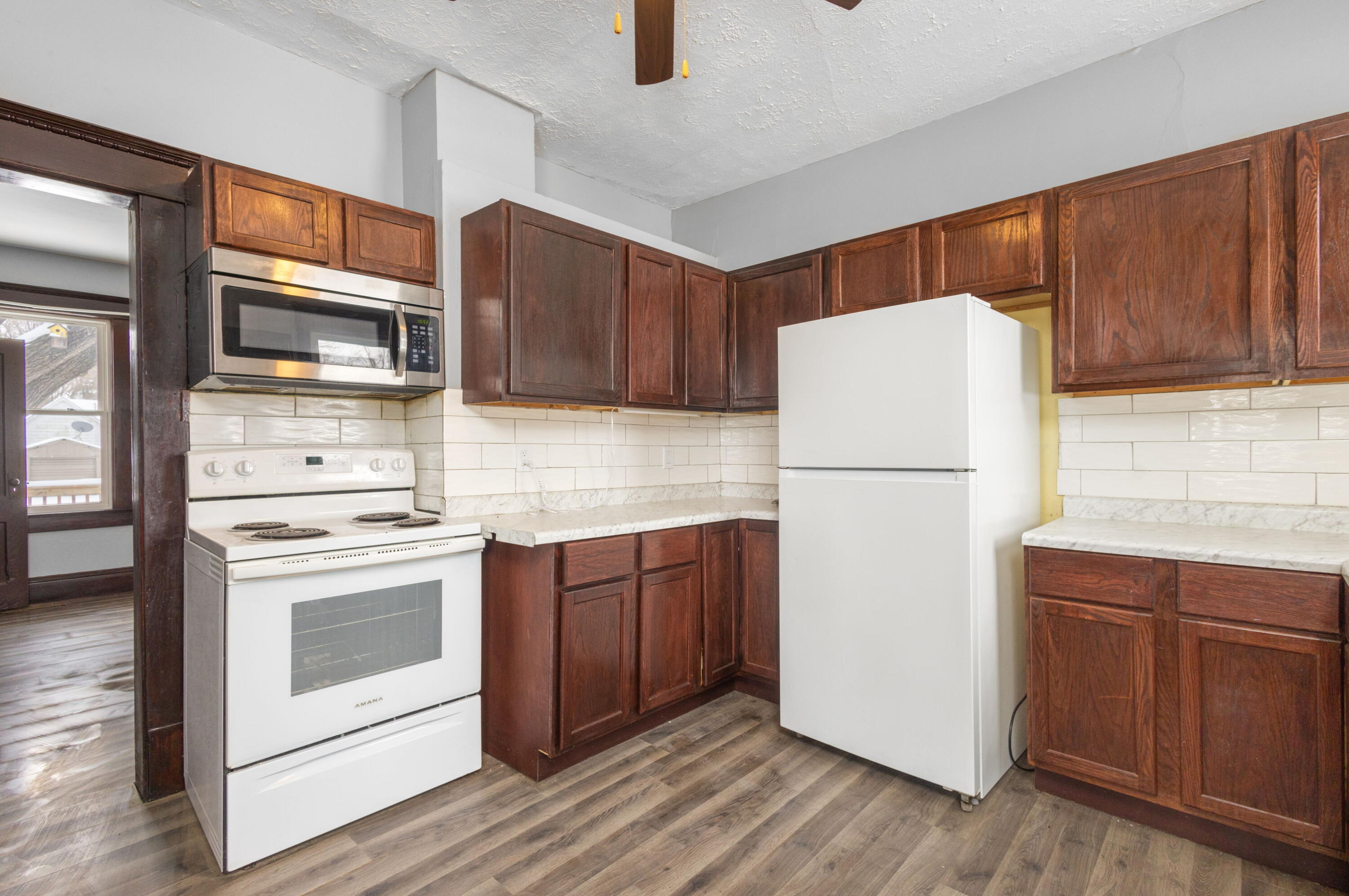 203 North Main Street Kingsbury, IN 46350 - Photo 10 of 32 a kitchen with a refrigerator sink and microwave