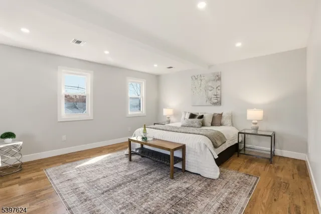 a spacious bedroom with a bed and a window