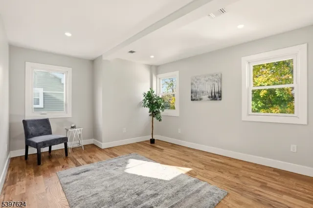 a view of a livingroom with furniture and a potted plant