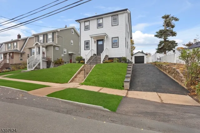 a view of a big house with a big yard and large tree
