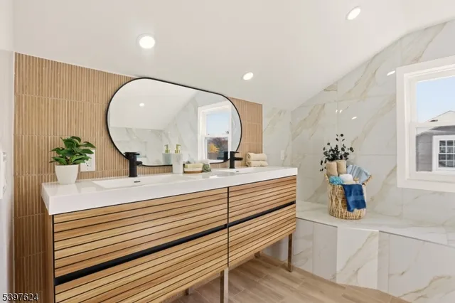 a bathroom with a sink mirror and vanity
