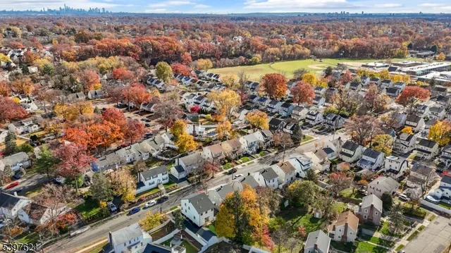 an aerial view of residential house with outdoor space and trees