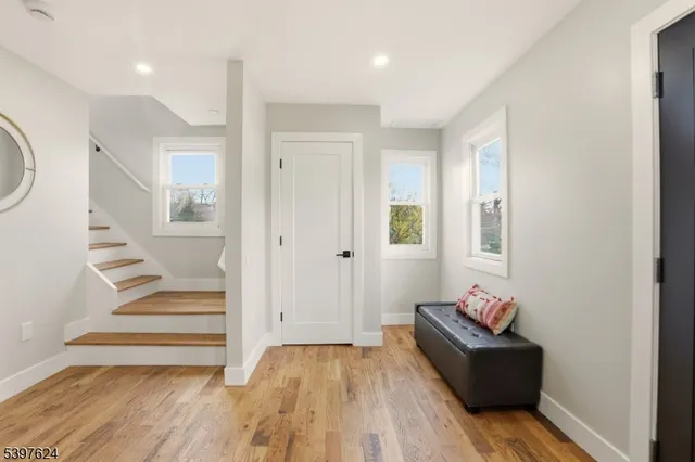 a view of entryway with wooden floor and stairs