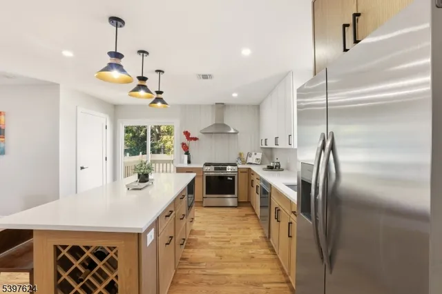 a kitchen with kitchen island a counter space a sink and appliances