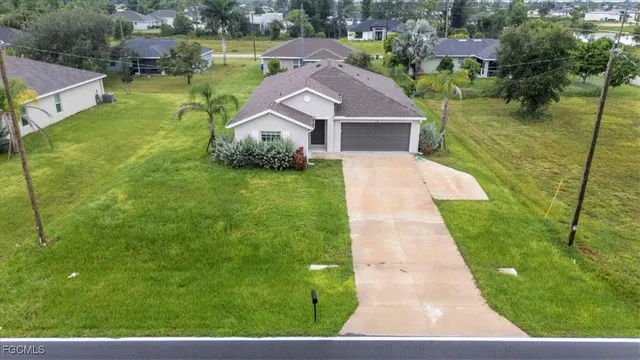 a aerial view of a house with a yard