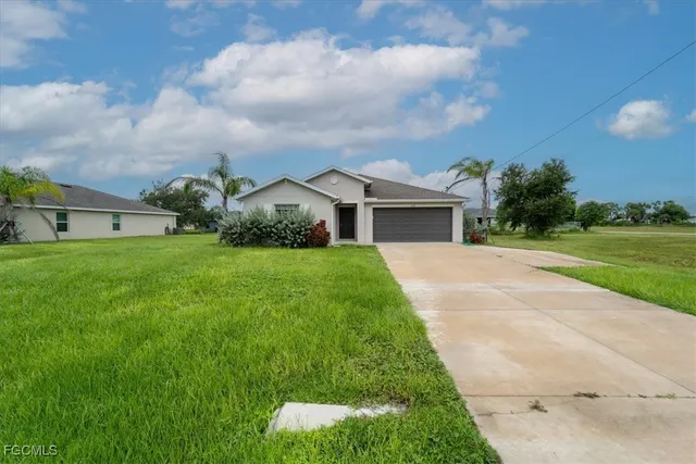 a front view of house with yard and green space