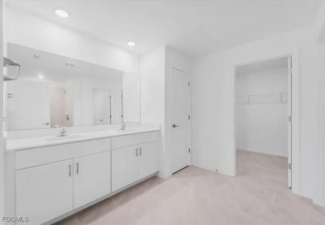 a bathroom with a double vanity sink and a mirror
