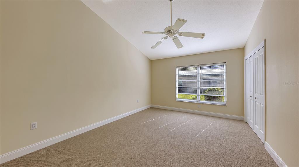 5860 Midnight Pass Road, Unit 40 Sarasota, FL 34242 - Photo 12 of 37 an empty room with a window and a fan