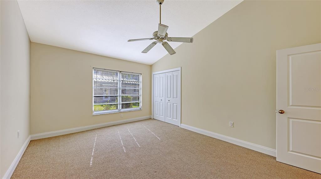 5860 Midnight Pass Road, Unit 40 Sarasota, FL 34242 - Photo 13 of 37 an empty room with windows and fan