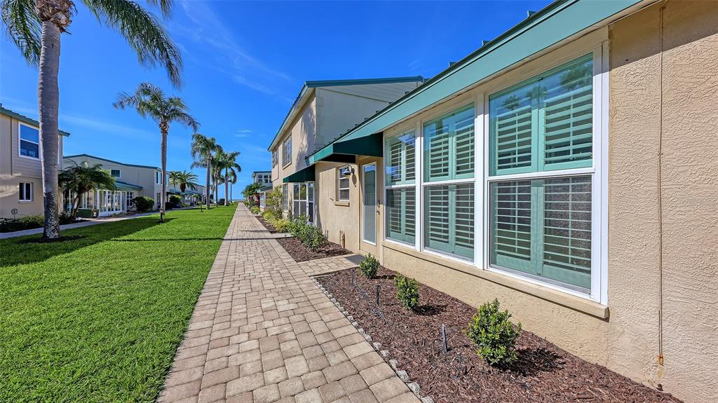 5860 Midnight Pass Road, Unit 40 Sarasota, FL 34242 - Photo 20 of 37 a view of a house with a yard