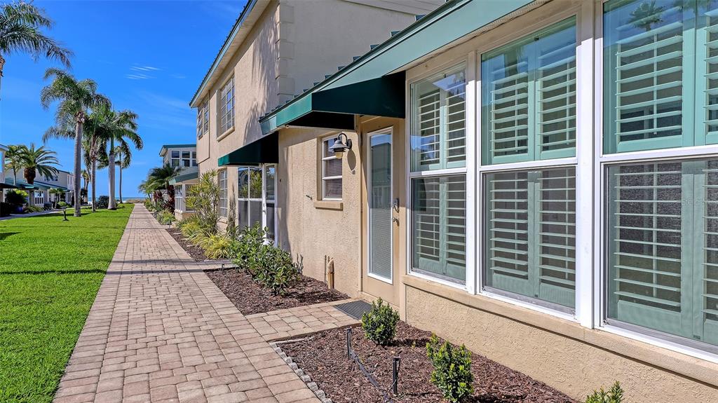 5860 Midnight Pass Road, Unit 40 Sarasota, FL 34242 - Photo 2 of 37 a front view of a house with a yard