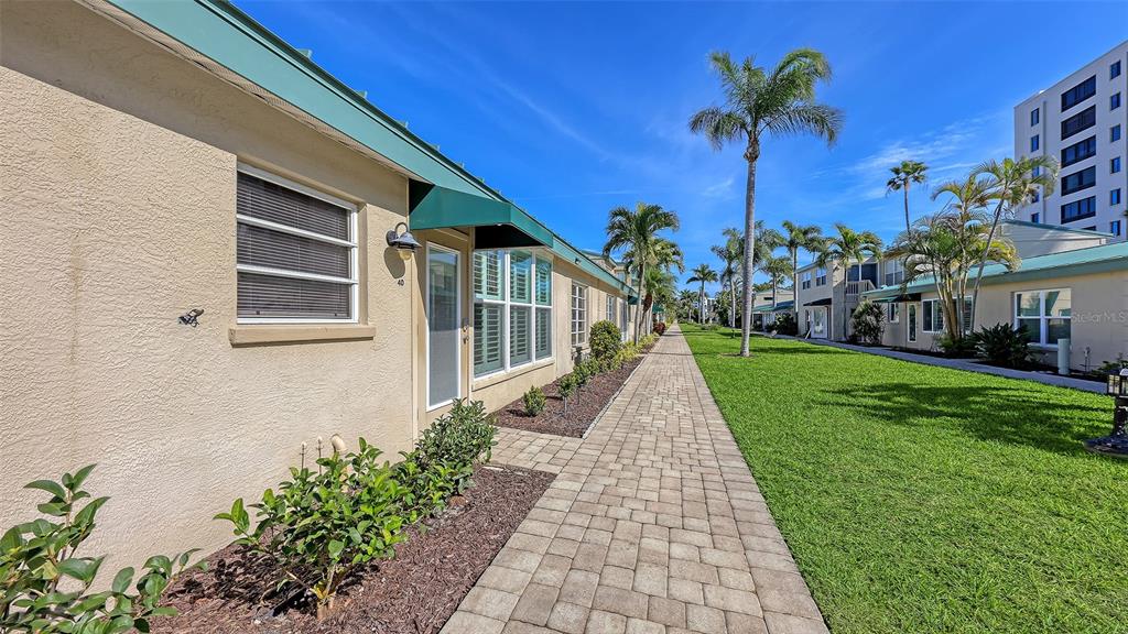 5860 Midnight Pass Road, Unit 40 Sarasota, FL 34242 - Photo 22 of 37 a view of a house with a yard